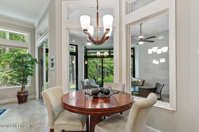 dining space featuring baseboards, ornamental molding, and ceiling fan with notable chandelier