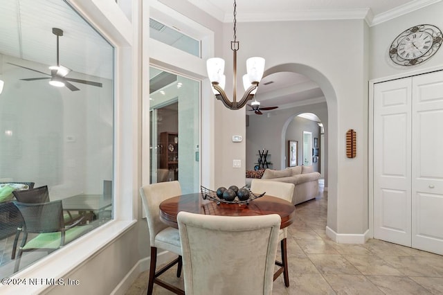 dining room featuring baseboards, arched walkways, ornamental molding, and ceiling fan with notable chandelier