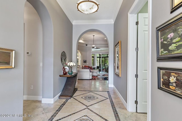 hallway with baseboards, arched walkways, and ornamental molding