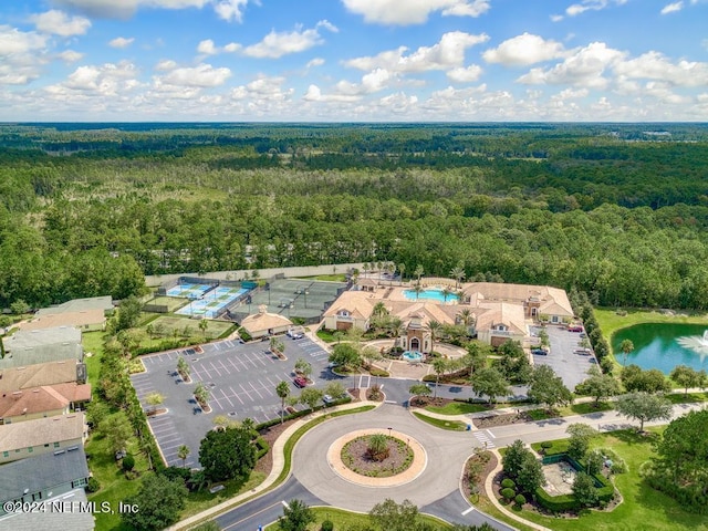 drone / aerial view with a wooded view