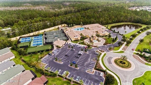 aerial view with a wooded view and a water view