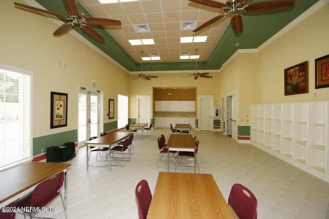 dining space featuring french doors, visible vents, a towering ceiling, and a paneled ceiling