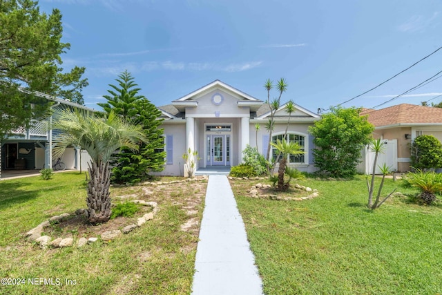 view of front of property featuring a front lawn and french doors