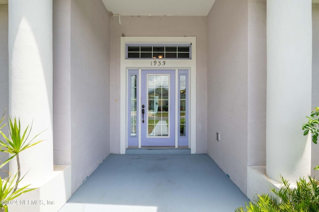 doorway to property with stucco siding