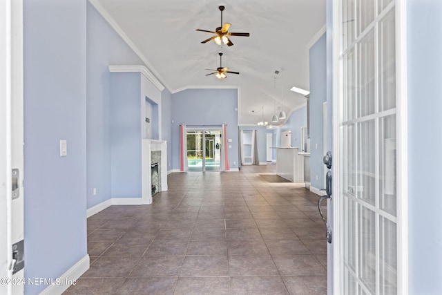 interior space featuring lofted ceiling, tile patterned flooring, a fireplace, baseboards, and ornamental molding