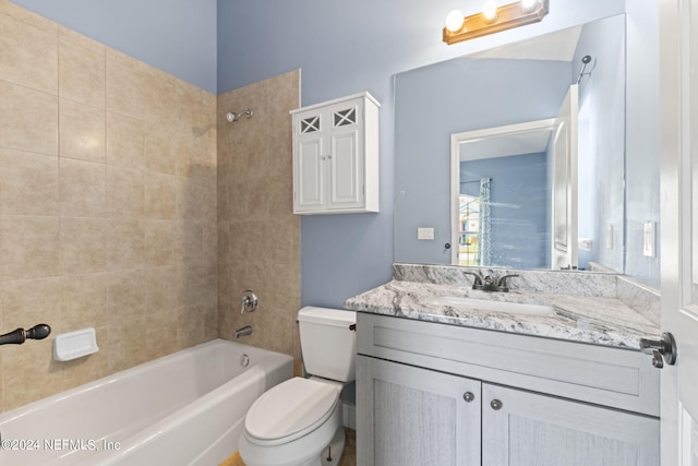 full bathroom featuring toilet, tiled shower / bath combo, and vanity