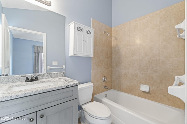 bathroom featuring  shower combination, vanity, and toilet