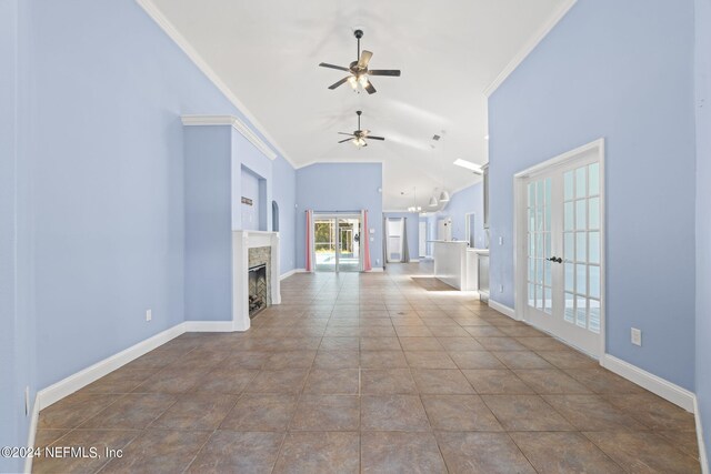 unfurnished living room with crown molding, french doors, ceiling fan, and tile patterned flooring