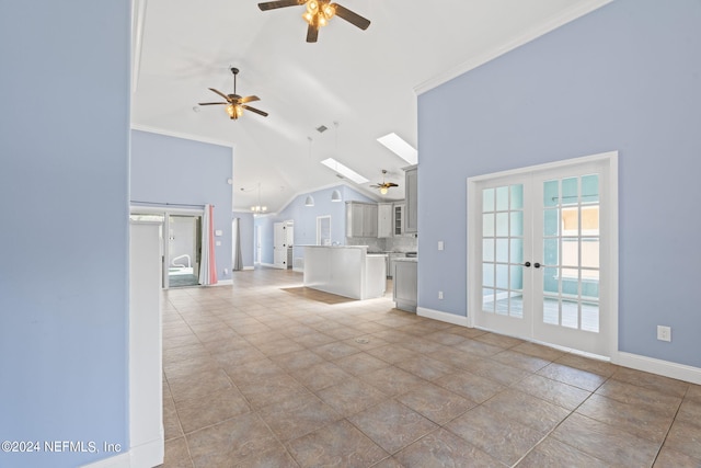 unfurnished living room featuring a skylight, ceiling fan, baseboards, and french doors