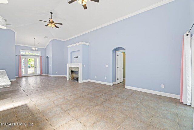 unfurnished living room featuring french doors, ornamental molding, high vaulted ceiling, ceiling fan, and light tile patterned flooring