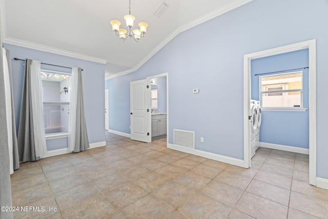 unfurnished dining area with vaulted ceiling, separate washer and dryer, light tile patterned floors, a notable chandelier, and ornamental molding