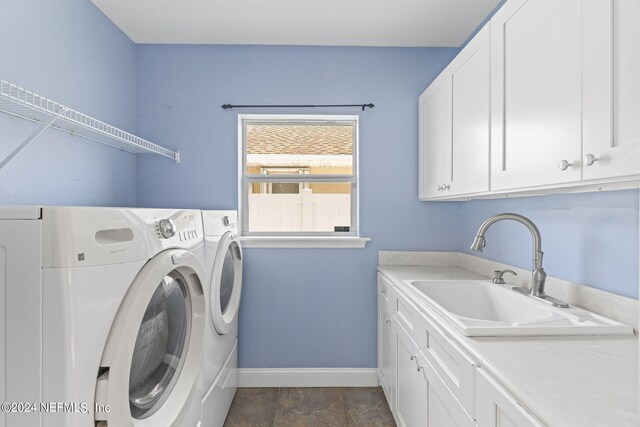 clothes washing area featuring tile patterned flooring, sink, cabinets, and separate washer and dryer