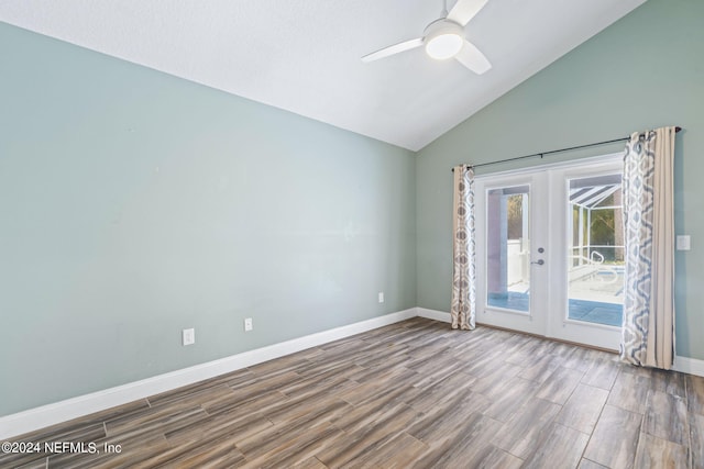 unfurnished room featuring french doors, vaulted ceiling, baseboards, and wood finished floors