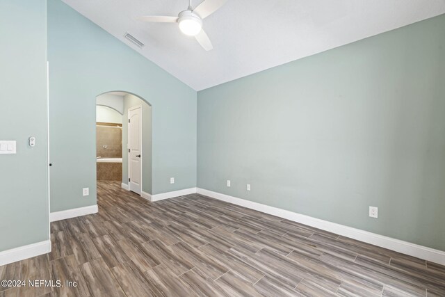 empty room featuring lofted ceiling and ceiling fan