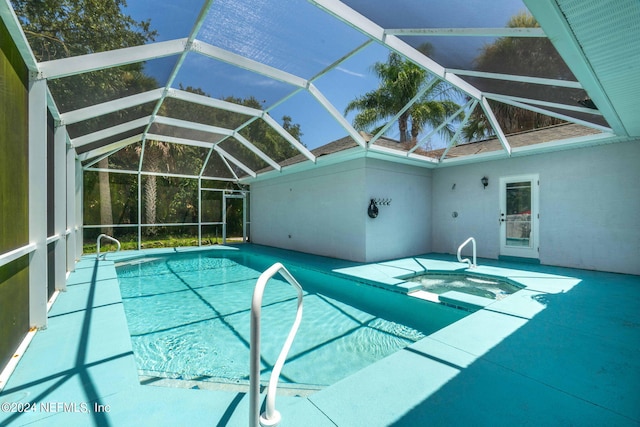 view of swimming pool featuring glass enclosure and a patio area