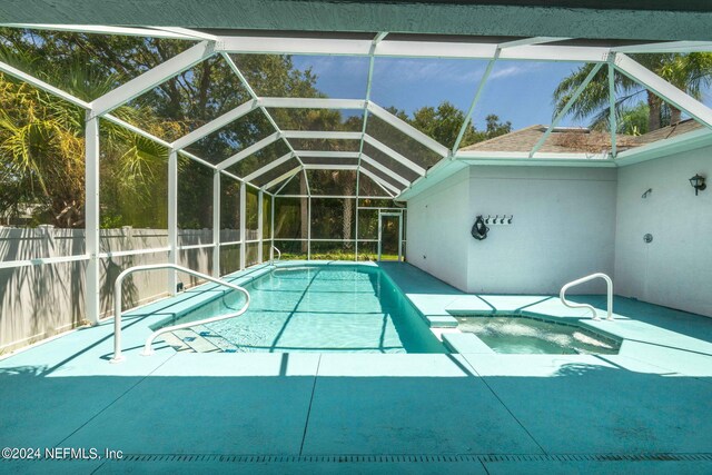 view of pool with a lanai and a patio