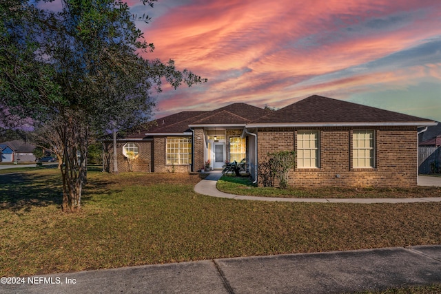 single story home featuring a yard