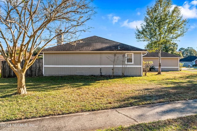 view of property exterior with a yard