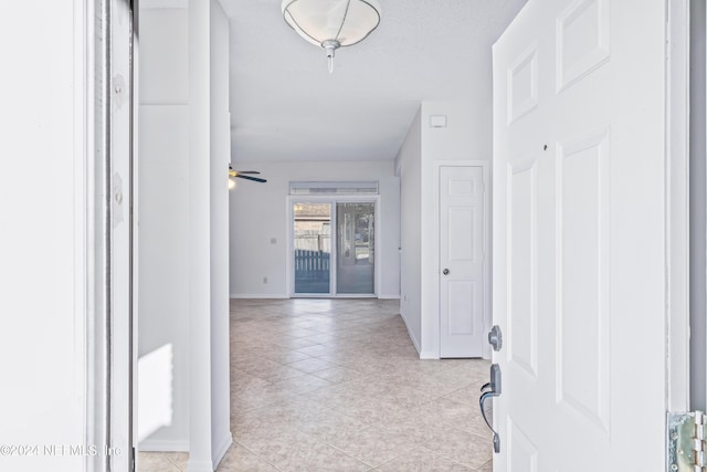 hallway featuring light tile patterned floors