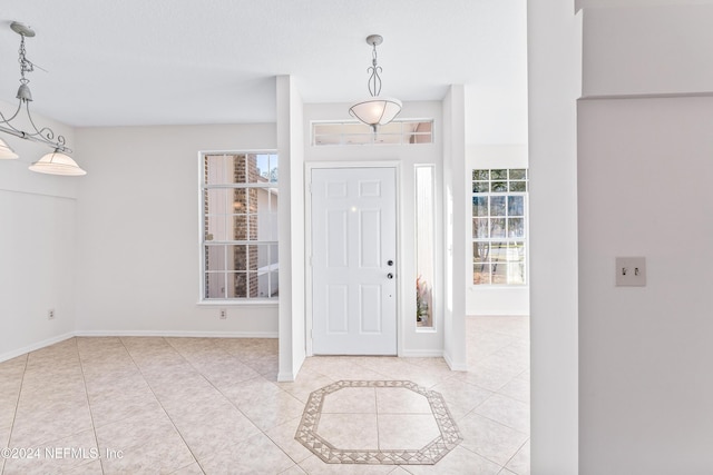 tiled entrance foyer featuring plenty of natural light