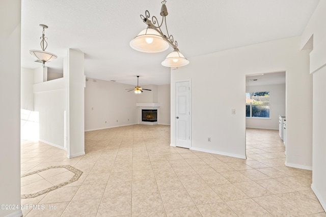 unfurnished living room with ceiling fan and light tile patterned floors