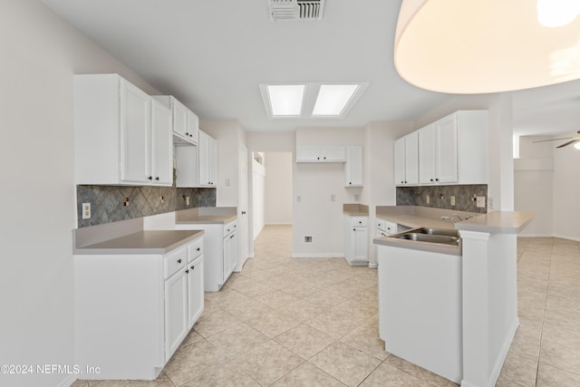 kitchen featuring ceiling fan, white cabinetry, sink, and light tile patterned floors