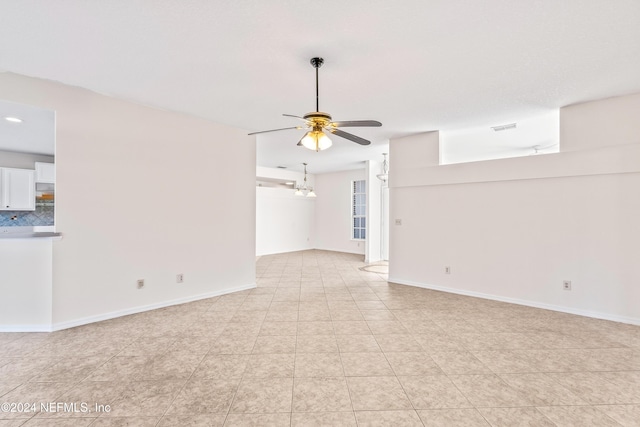 unfurnished living room featuring ceiling fan and light tile patterned flooring