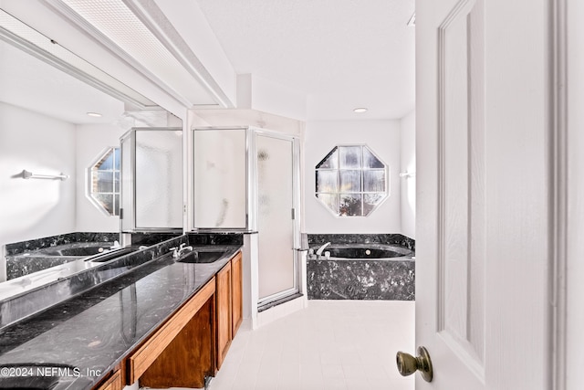 bathroom featuring plus walk in shower and vanity