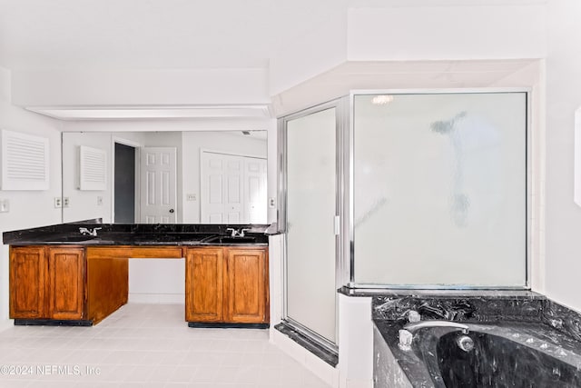 kitchen with sink and dark stone counters