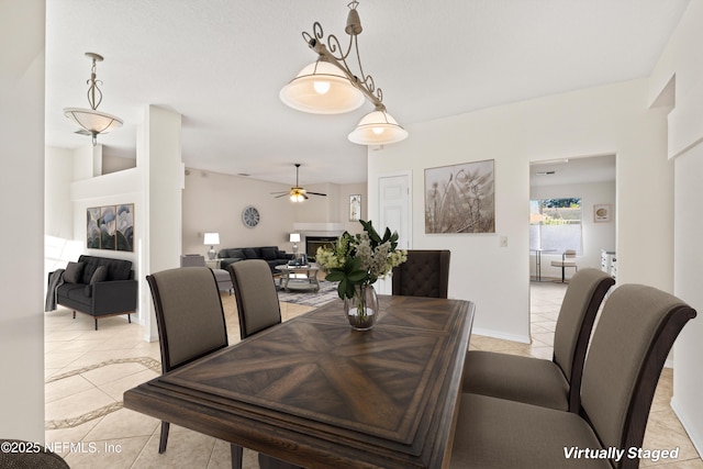 tiled dining space featuring ceiling fan