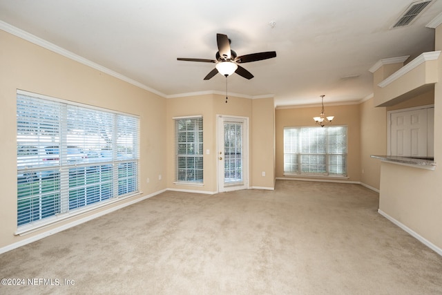 unfurnished living room with a wealth of natural light, light carpet, and ceiling fan with notable chandelier