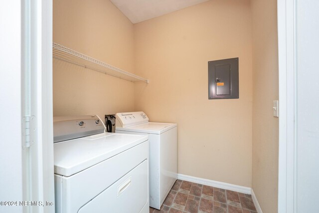 washroom featuring electric panel, separate washer and dryer, and tile patterned floors