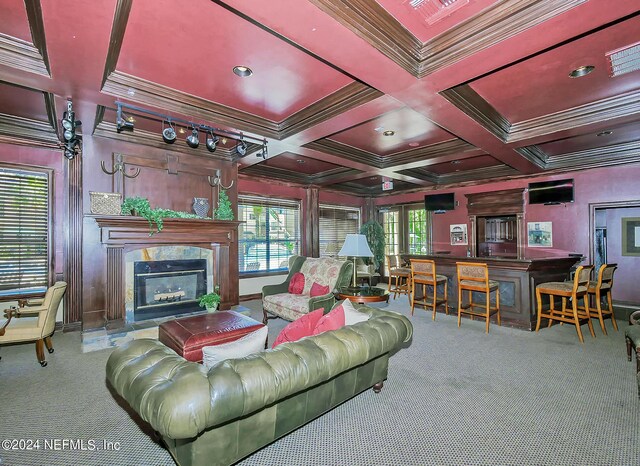 carpeted living room with a fireplace, coffered ceiling, crown molding, and beam ceiling