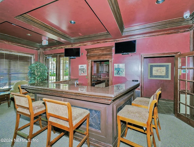 kitchen with ornamental molding and carpet flooring