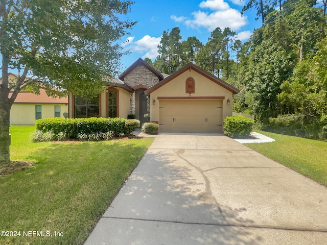 view of front of home featuring a front yard and a garage