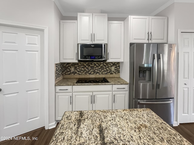 kitchen with stone countertops, white cabinets, and stainless steel fridge