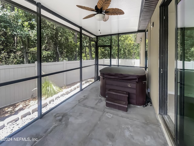 unfurnished sunroom featuring a ceiling fan