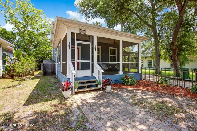 rear view of house with a patio and a sunroom