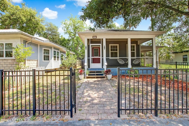 view of front of house featuring a fenced front yard, entry steps, and a gate