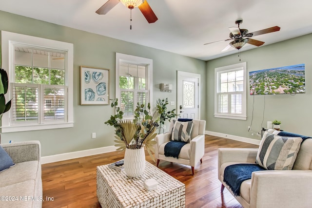 sitting room featuring ceiling fan, baseboards, and wood finished floors