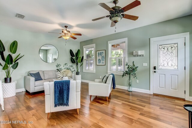 living room with ceiling fan and light wood-type flooring