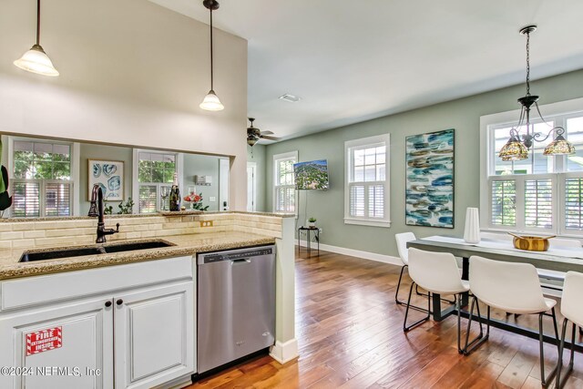 kitchen featuring dishwasher, hardwood / wood-style flooring, and plenty of natural light