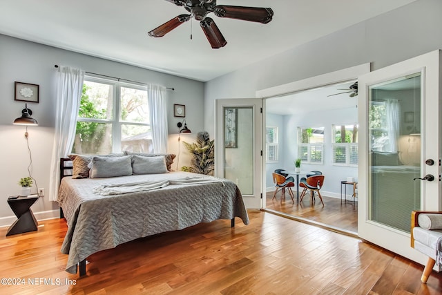 bedroom with light wood-style flooring, multiple windows, baseboards, and ceiling fan