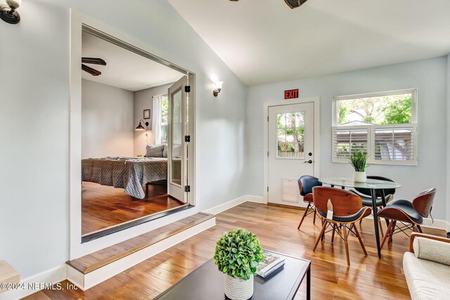 interior space featuring ceiling fan, light hardwood / wood-style floors, and lofted ceiling