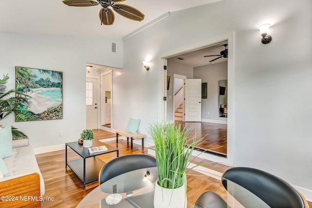 interior space featuring lofted ceiling, visible vents, light wood-style flooring, ceiling fan, and stairs