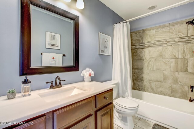 full bathroom featuring tile patterned flooring, shower / bath combination with curtain, vanity, and toilet