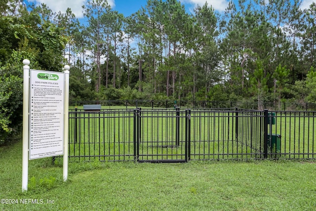 view of gate featuring a lawn