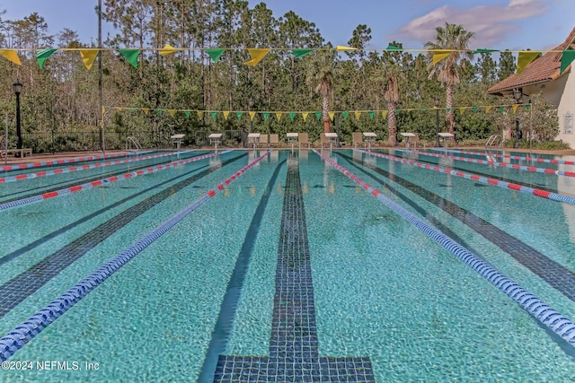 view of pool at dusk