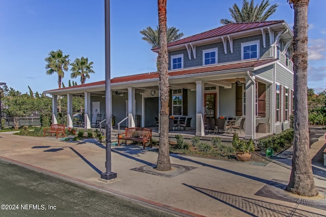 view of front of house with ceiling fan and a porch