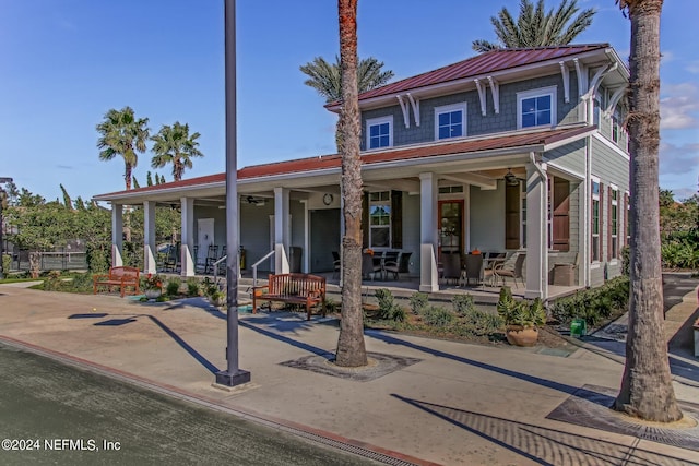 view of front of property with covered porch, ceiling fan, and metal roof